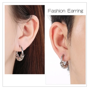 Hip hop punk cone hoop earring with detailed engravings shown on male and female models