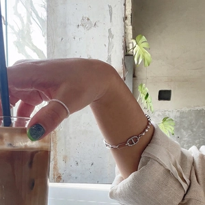 S925 sterling silver beaded bracelet with pig nose link shown in a casual lifestyle setting