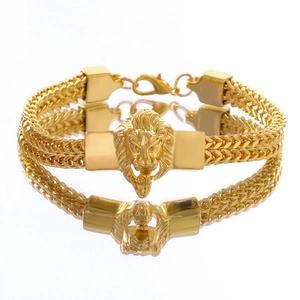 Close-up of golden lion head relief and dense metal woven chain with lobster clasp
