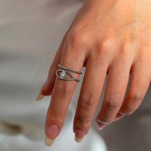 Close-up of double-layer silver titanium steel ring with evil eye and bead texture