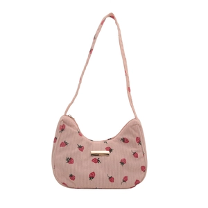 Pink corduroy underarm bag with red strawberry print and gold metal hardware on white background