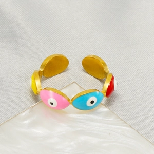 Detail of gold evil eye adjustable ring featuring pink blue red and yellow enamel charms