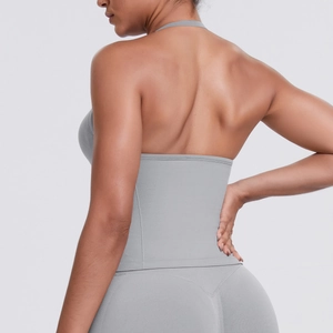 Detail of grey halter sports top and high-waist yoga pants with cross-back design