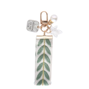 Bohemian embroidered ribbon keychain with pearl, leaf charm and sea quote pendant