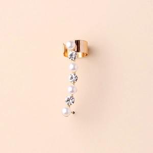 Detailed view of gold ear cuff featuring alternating white pearls and sparkling rhinestones