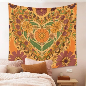 Detail of bohemian floral heart tapestry hanging over a bedroom bed as wall decor