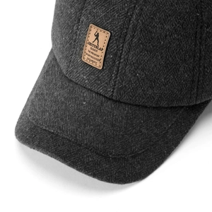 Detail of winter baseball cap showing charcoal wool texture and leather golf logo patch
