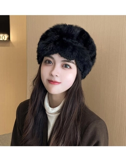 Detail of hand-crocheted rabbit fur knit hat in black with delicate hollow flower pattern
