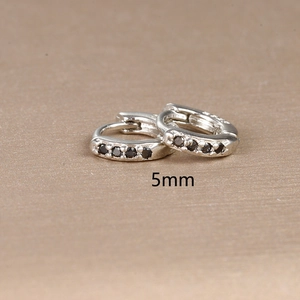 Macro shot of 5mm silver earrings with black zircon stones and S925 hallmark
