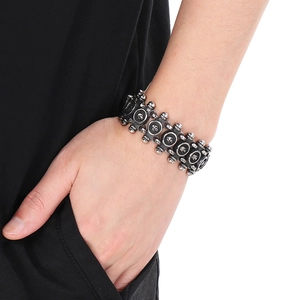 Men's punk style skull link bracelet in vintage silver finish on wrist