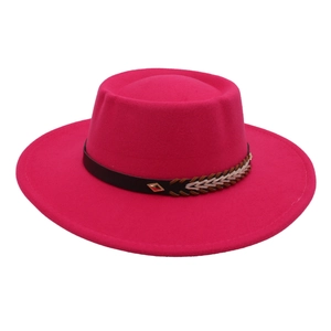 Close-up of red flat top felt hat with woven leather band and metal buckle detail