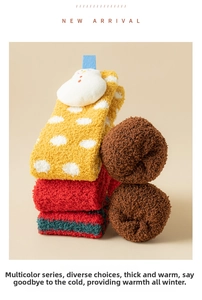 Detailed close-up of thick coral fleece socks with cute 3D snowman and colorful stripes