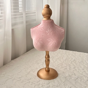 Detailed view of pink floral embossed velvet jewelry mannequin bust with golden stand