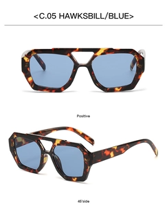 Detail view of tortoiseshell frames with blue lenses in a double bridge irregular design