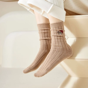 Detailed view of camel knit socks featuring a cute cartoon bear embroidery on the side