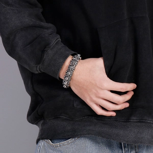 Close-up of vintage skull link bracelet in silver finish worn by a model on the wrist
