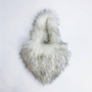 Detailed view of the soft white and grey faux raccoon fur texture on children's shell bag