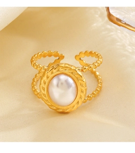 Macro view of a gold-plated stainless steel ring with white pearl and beaded band details