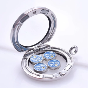 Macro detail of silver floating charms locket showing you are my sun enamel inserts