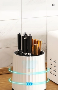Close-up of a white rotating kitchen tool holder with 360-degree swivel for cutlery storage