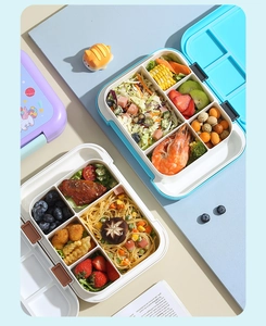 Detail of four-compartment blue and purple bento boxes showing food separation and side locks