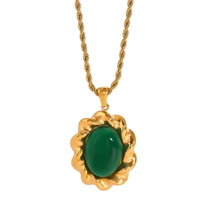 Macro shot of vintage gold twisted rope frame surrounding a large oval green gemstone pendant
