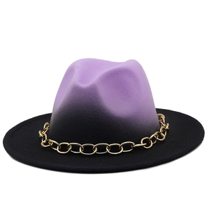 Detail of gold metal chain on gradient purple to black wide-brim wool felt fedora hat