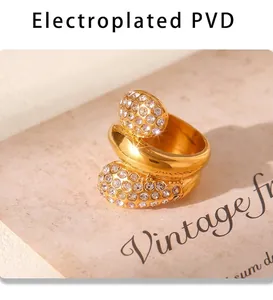 Detail of PVD gold-plated coiled ring featuring shimmering clear pavé zircon settings