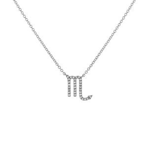 Macro shot of silver Scorpio necklace pendant with sparkling cubic zirconia on white background