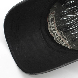 Close-up of baseball cap interior showing sewing lines and Adventure lettering detail