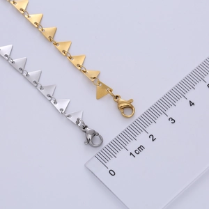 Detailed close-up of geometric triangle pendant necklaces in gold and silver steel finish