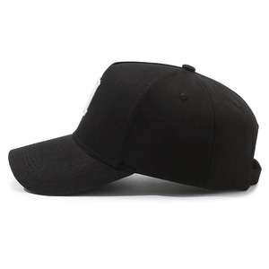 Classic black cotton baseball cap with white embroidery side profile on white background