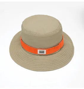 Detail of khaki outdoor bucket hat with orange band showing durable stitching and logo