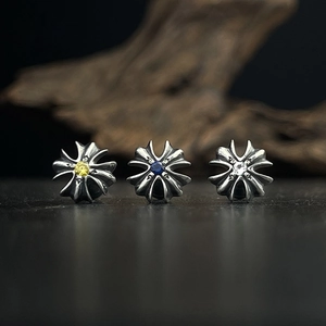 Detail of 925 sterling silver cross stud earrings with colorful zircon stone inlay