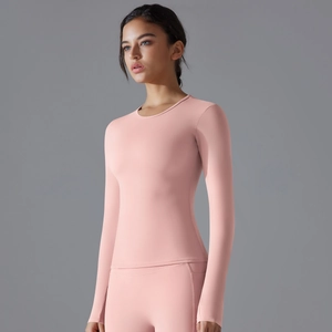 Close-up of pink long sleeve yoga top featuring slim fit design and ergonomic cut