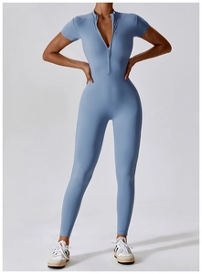Detail view of the sleek front zipper closure on the blue short sleeve yoga bodysuit
