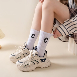 Macro detail of breathable cream leather mesh sneaker with vintage contrast stripes
