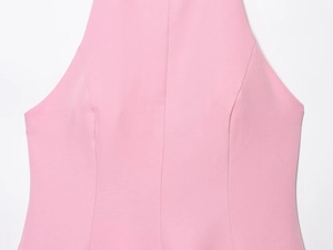 Detail of front seam and fabric texture on light pink backless halter dress