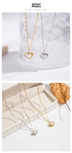 Detailed view of gold and silver shell heart necklaces on display and in a jewelry box