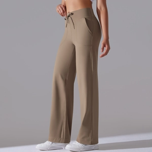 Detail of high-waist khaki wide-leg yoga pants featuring elastic drawstring and side pockets