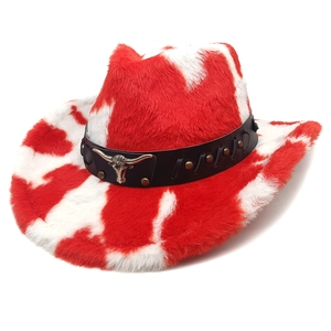 Detail of plush red cow print cowboy hat with faux leather band and metal bull head