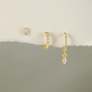 Macro shot of gold-plated S925 silver hoop earrings set with sparkling zircon accents