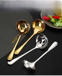 Detailed view of polished gold and silver 304 stainless steel soup spoons and ladles