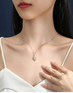 Close-up of S925 silver leaf pendant necklace featuring a brilliant round D color moissanite