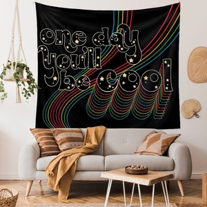 Detail of bohemian black tapestry with 'one day you'll be cool' text and rainbow waves