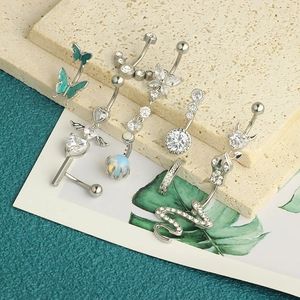 Detail showing assorted stainless steel navel rings with butterfly and heart zircon charms
