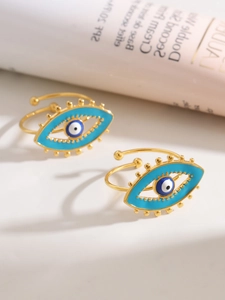 Detail of gold evil eye rings featuring blue enamel inlay and adjustable open band