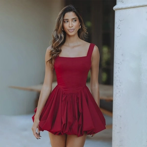 Detail shot of a red sleeveless mini dress featuring a square neck and puffed hemline