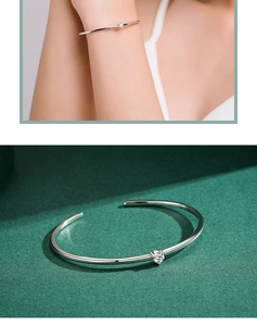 Close-up of a s925 sterling silver open ring bracelet with a sparkling crystal stone