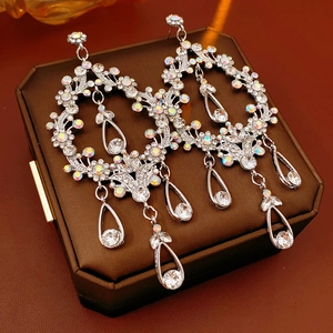Macro shot of silver teardrop tassel earrings with sparkling rhinestones on jewelry box